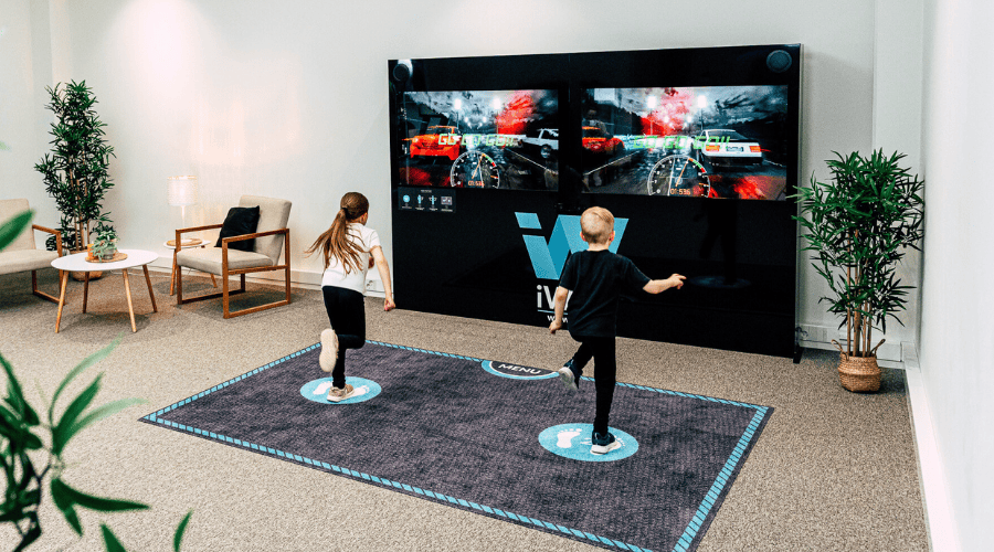 kids playing street racing on iWall interactive game